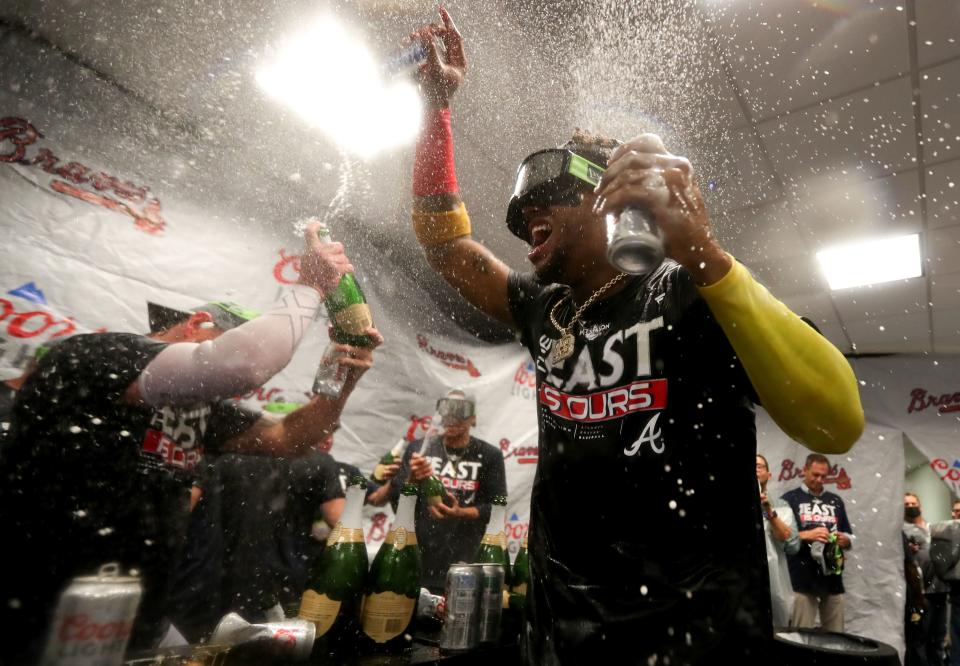 MIAMI, FLORIDA - OCTOBER 04: Ronald Acuna Jr. #13 of the Atlanta Braves celebrates after clinching the division against the Miami Marlins at loanDepot park on October 04, 2022 in Miami, Florida. (Photo by Megan Briggs/Getty Images)