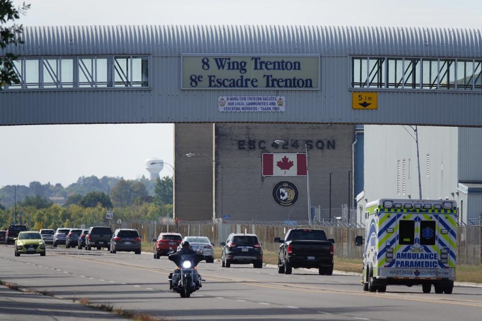 Vehicles drive along a road running through CFB Trenton on Sept. 28, 2023.