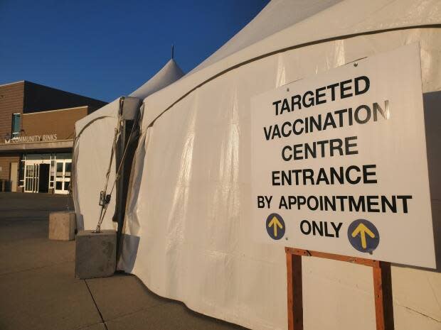 People with vaccine appointments are screened for symptoms of COVID-19 prior to entry at the WFCU Centre.