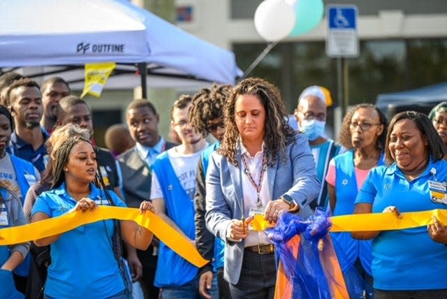 Jessi Holden, manager of the newly renovated Walmart Neighborhood Market in suburban Lake Worth, leads a ribbon-cutting ceremony for the store's reopening on Nov. 3, 2023.