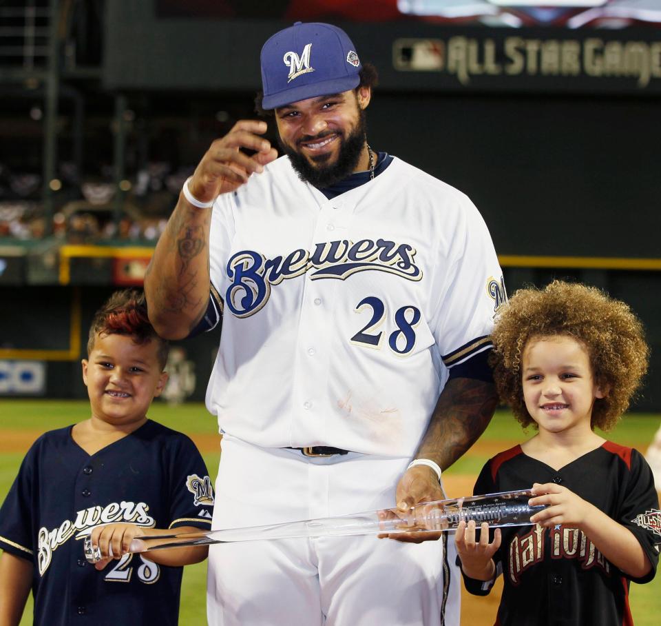 Milwaukee Brewers' Prince Fielder and his sons Jadyn (R) and Haven hold his All-Star Game MVP trophy after Major League Baseball's All-Star Game in Phoenix, Arizona July 12, 2011.