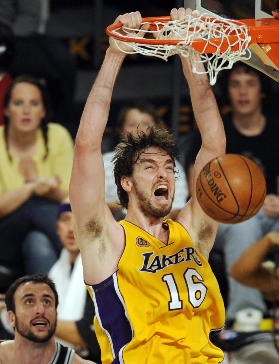 FILE - Los Angeles Lakers' Pau Gasol (16), of Spain, dunks as San Antonio Spurs' Manu Ginobili, left, of Argentina, looks on during the second half of Game 5 of the NBA Western Conference basketball finals in Los Angeles, May 29, 2008. Gasol was announced Friday, Feb. 17, 2023, as being among the finalists for enshrinement later this year by the Basketball Hall of Fame. The class will be revealed on April 1. (AP Photo/Chris Pizzello, File)