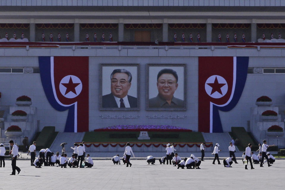 North Koreans prepare under portraits of the country's late leaders, Kim Il Sung, left, and Kim Jong Il, right, on Kim Il Sung Square, ahead of the 70th anniversary of North Korea's founding day in Pyongyang, North Korea, Friday, Sept. 7, 2018. North Korea will be staging a major military parade, huge rallies and reviving its iconic mass games on Sunday to mark its 70th anniversary as a nation. (AP Photo/Kin Cheung)