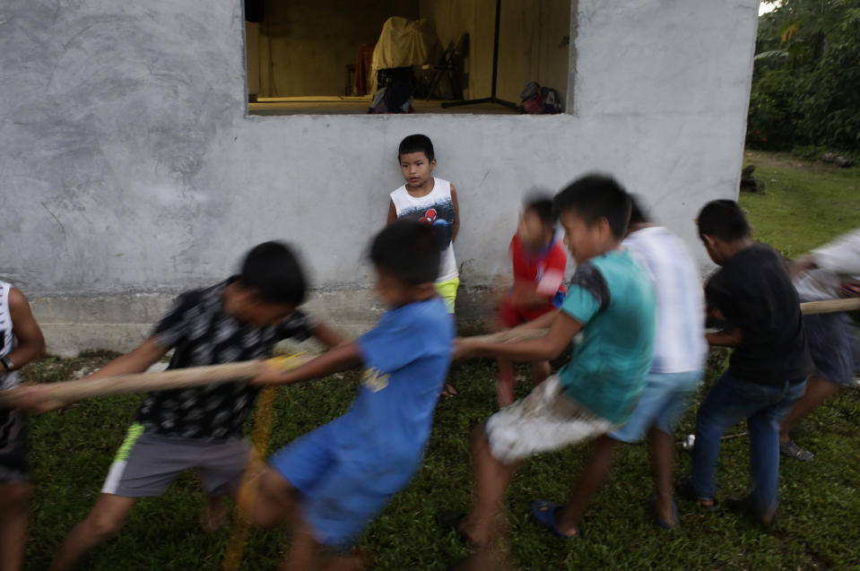 In this Nov. 25, 2018 photo, a group of children play tug-of-war away from the second edition of the Panamanian indigenous games in Piriati, Panama. (AP Photo/Arnulfo Franco)