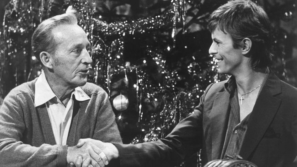 Bing Crosby and David Bowie shake hands during the taping of the television special 