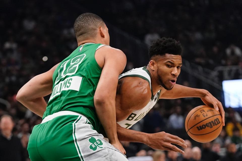 Milwaukee Bucks' Giannis Antetokounmpo tried to get past Boston Celtics' Grant Williams during the first half of an NBA basketball game Thursday, April 7, 2022, in Milwaukee. (AP Photo/Morry Gash)