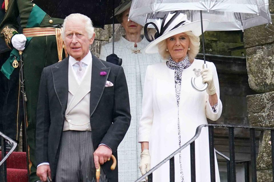 <p>JONATHAN BRADY/POOL/AFP via Getty </p> King Charles and Queen Camilla host guests for a Garden Party at Holyroodhouse in Edinburgh