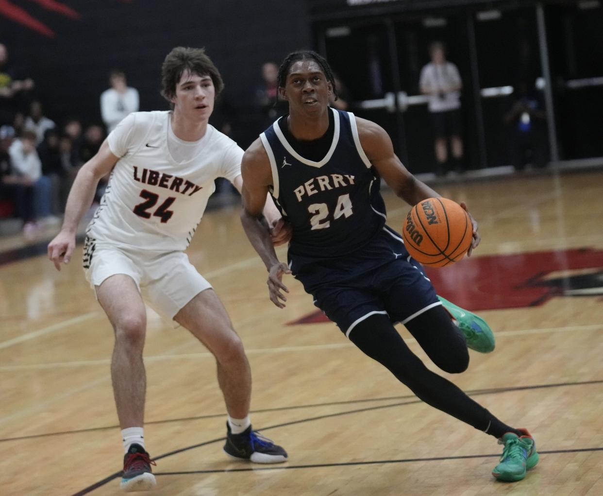 Perry guard Cody Williams (24) goes to the basket against Liberty forward Caden Hunter (24) at Liberty High School gym in Peoria, Ariz., on Nov. 29, 2022.