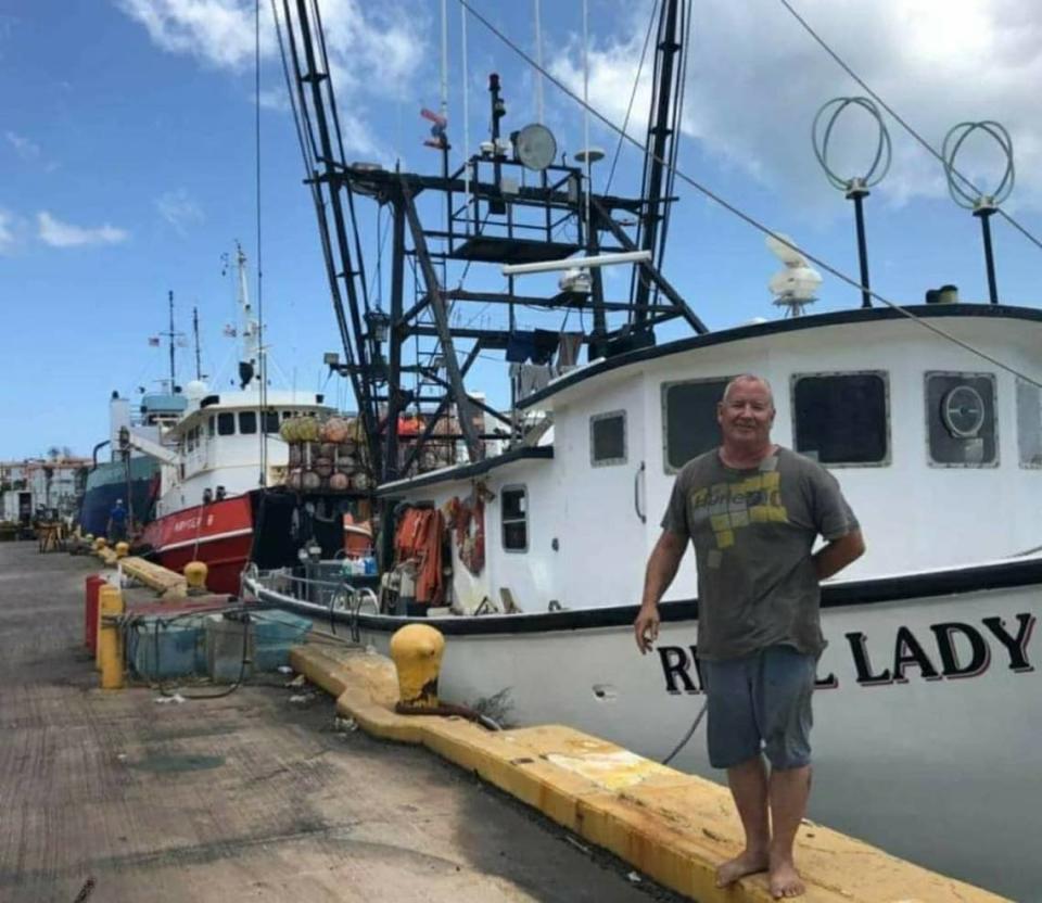 Michael Foy in front of his boat the Rebel Lady