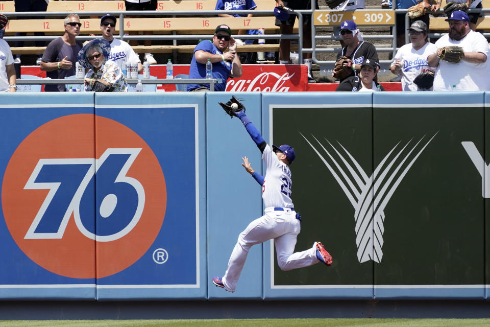 Los Angeles Dodgers center fielder Trayce Thompson makes a leaping catch on a line drive from Washington Nationals' Luis Garcia during the fifth inning of a baseball game Wednesday, July 27, 2022, in Los Angeles. (AP Photo/Marcio Jose Sanchez)