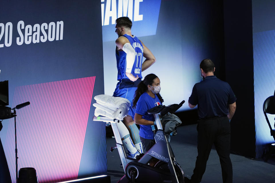 Dallas Mavericks' Luka Doncic (77) goes to the locker room after being injured during the second half of an NBA basketball first round playoff game against the Los Angeles Clippers Friday, Aug. 21, 2020, in Lake Buena Vista, Fla. (AP Photo/Ashley Landis, Pool)