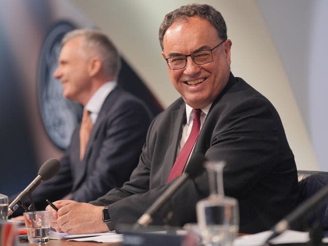 Andrew Bailey, governor of the Bank of England, sitting at desk smiling