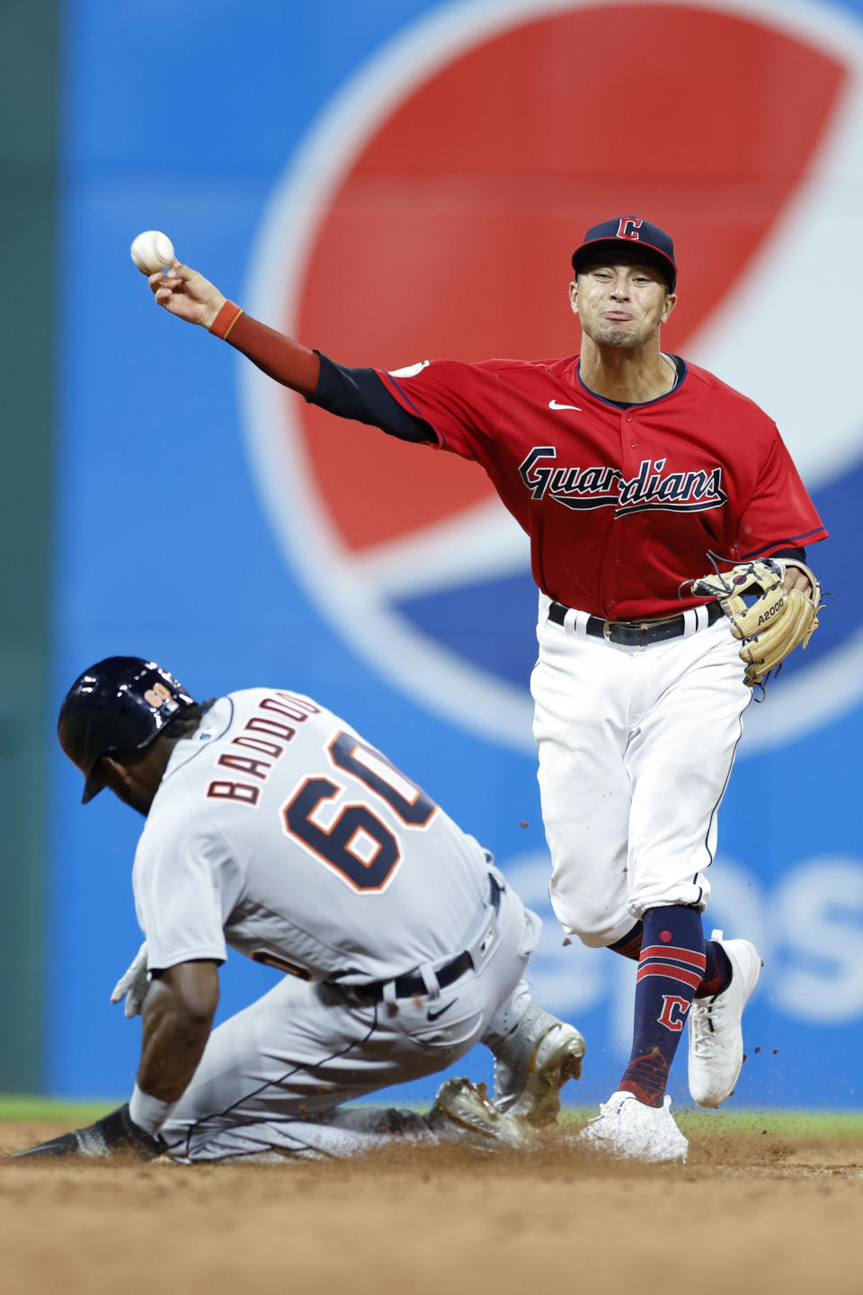 Cleveland Guardians shortstop Tyler Freeman throws to first after forcing out Detroit Tigers' Akil Baddoo, completing a double play on Riley Greene during the sixth inning of a baseball game Tuesday, Aug. 16, 2022, in Cleveland. (AP Photo/Ron Schwane)