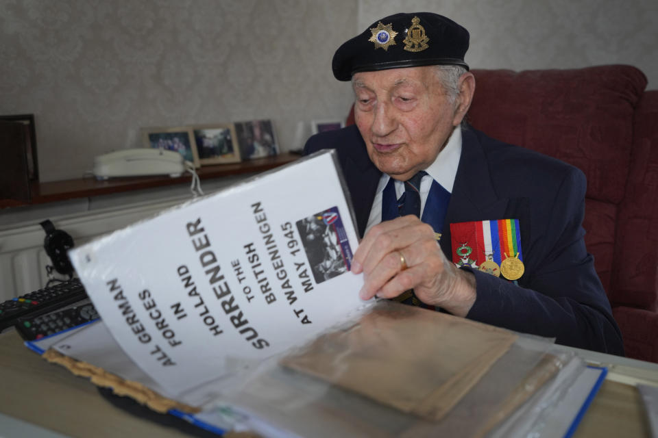 Mervyn Kersh D-Day veteran who fought in the Normandy Campaign, looks through documents and newspapers from the Second World War era at his home in London, Monday, April 8, 2024. A Jewish veteran is preparing to commemorate the 80th anniversary of the D-Day landings. Pvt. Mervyn Kersh was summoned by his commanding officer and threatened with arrest even as he prepared to embark for the battlefields of Normandy eight decades ago. (AP Photo/Kirsty Wigglesworth)