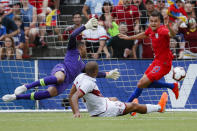 Venezuela forward Jose Salomon Rondon, center, scores against United States goalkeeper Zack Steffen (1) and defender Aaron Long (23) during the first half of an international friendly soccer match, Sunday, June 9, 2019, in Cincinnati. (AP Photo/John Minchillo)