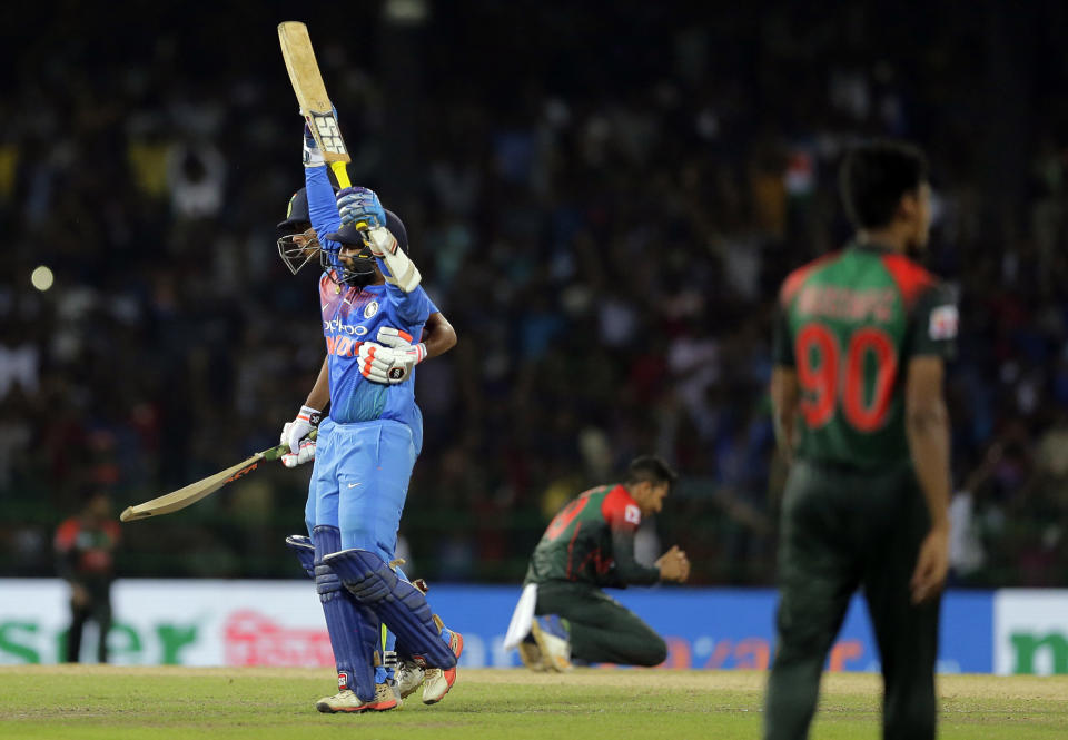 India’s Dinesh Karthik, left, celebrates scoring the winning run to defeat Bangladesh by four wickets during the finals of Nidahas triangular Twenty20 cricket series in Colombo, Sri Lanka, Sunday, March 18, 2018. (AP Photo/Eranga Jayawardena)