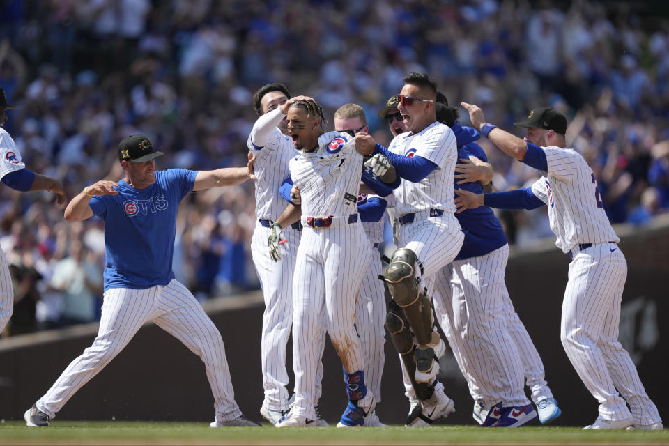 Chicago Cubs' Christopher Morel, center, celebrates with teammates after his game-winning RBI single scored Cody Bellinger in the ninth inning of a baseball game against the Pittsburgh Pirates Saturday, May 18, 2024, in Chicago. The Cubs won 1-0. (AP Photo/Charles Rex Arbogast)