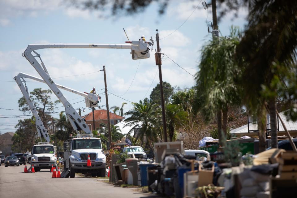 Electricity crews work in the Island Park neighborhood of South Fort Myers on Wednesday, Oct. 5, 2022. The area was devastated by Hurricane Ian.