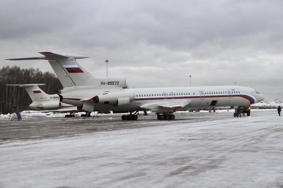 This photo taken on Thursday, Jan. 15, 2015 shows the Tu-154 plane with registration number RA-85572, foreground, at Chkalovsky military airport near Moscow, Russia. A Russian plane with 92 people aboard, including a well-known military band, crashed into the Black Sea on its way to Syria on Sunday, Dec. 25, 2016, minutes after takeoff from the resort city of Sochi, the Defense Ministry said. The Tu-154, the same plane shown in this photo, which belonged to the Defense Ministry, was taking the Alexandrov Ensemble to a concert at the Russian air base in Syria. (AP Photo/Dmitry Petrochenko)