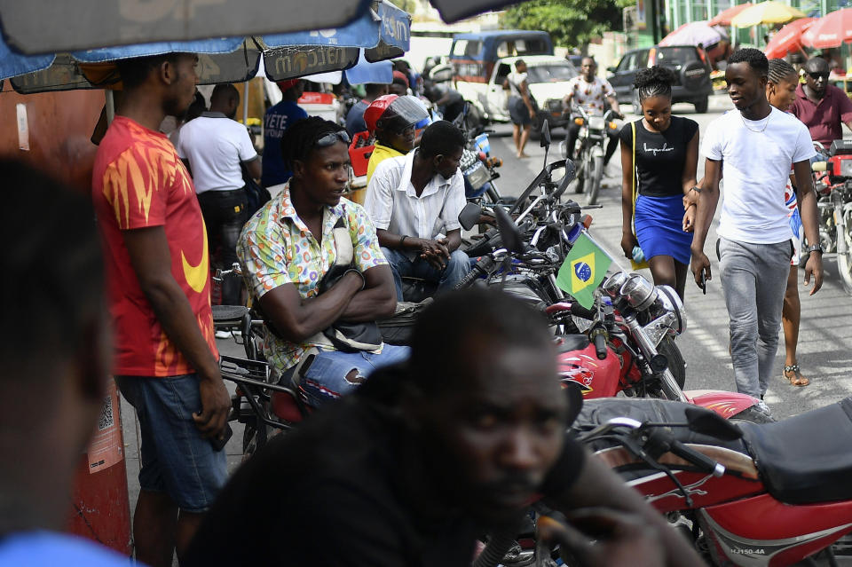 Mototaxi drivers wait for customers in Port-au-Prince, Haiti, Saturday, July 10, 2021, three days after President Jovenel Moise was assassinated in his home. (AP Photo/Matias Delacroix)