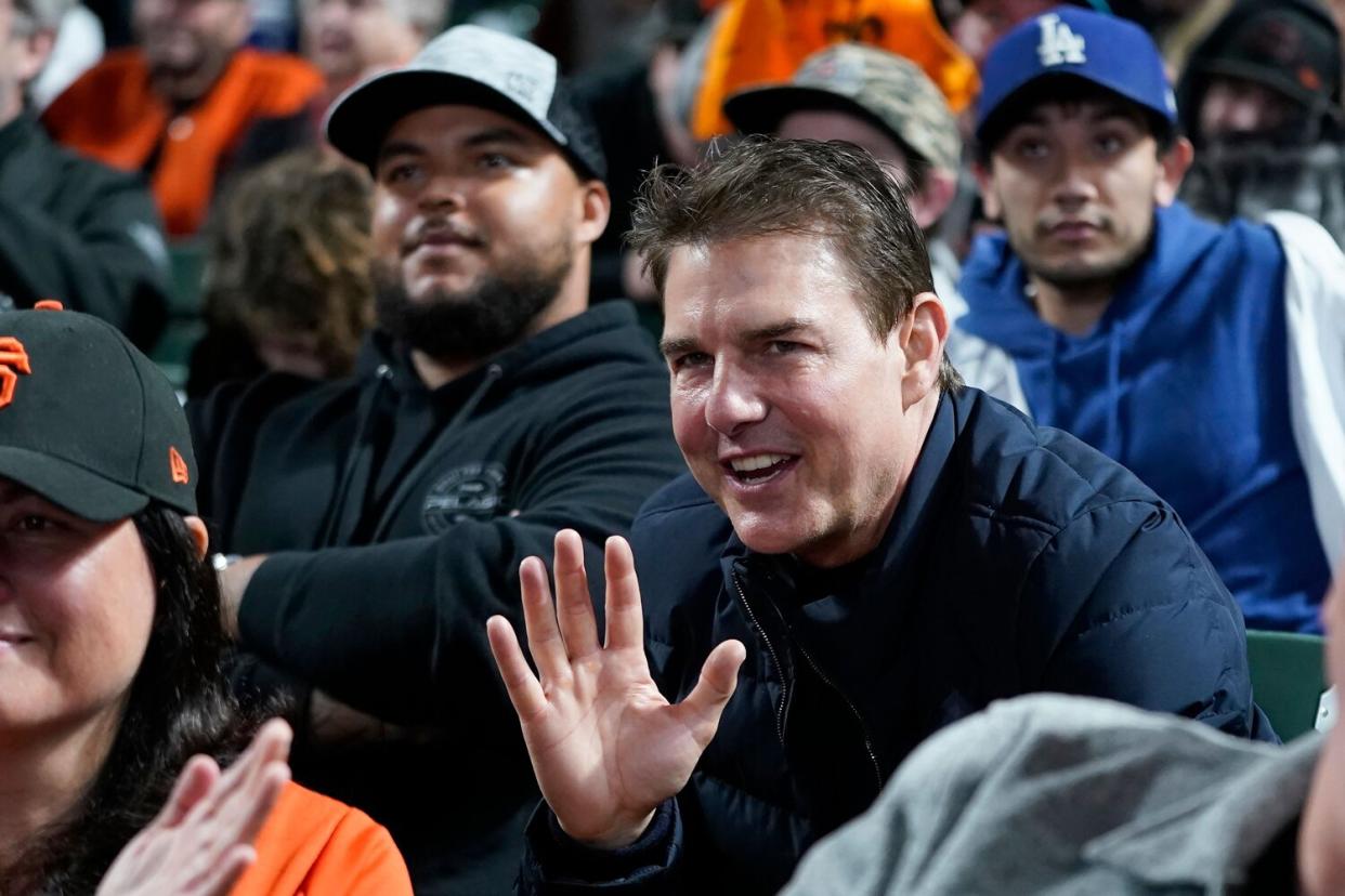 Tom Cruise smiles during Game 2 of a baseball National League Division Series between the San Francisco Giants and the Los Angeles Dodgers