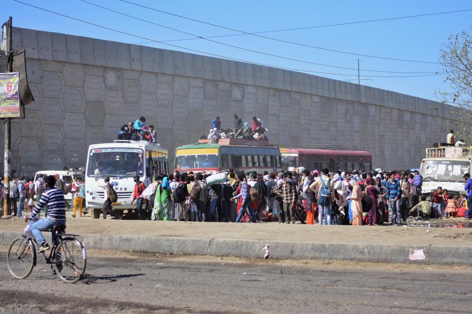 DELHI, INDIA - 2020/03/29: Crowd of migrant workers at Anand vihar bus terminal travelling to their villages, during the nationwide lock down. The Indian government imposed a 21 day nationwide lock down as a preventive measure against the corona virus pandemic. (Photo by Manish rajput/SOPA Images/LightRocket via Getty Images)