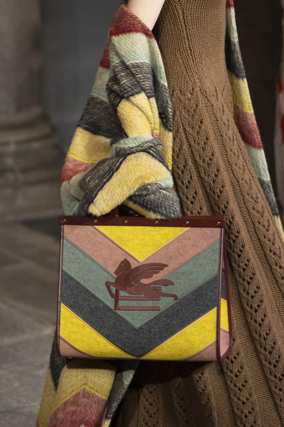 A suede striped bag and matching knitwear from Etro fall winter ’23. - Credit: Gamma-Rapho via Getty Images