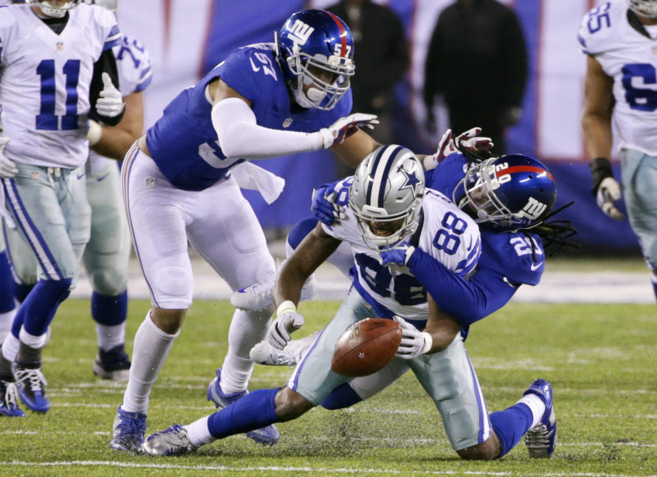 Dallas Cowboys wide receiver Dez Bryant (88) fumbles the ball during the second half of an NFL football game as New York Giants' Janoris Jenkins (20) and Keenan Robinson (57) defend Sunday, Dec. 11, 2016, in East Rutherford, N.J. (AP Photo/Seth Wenig)