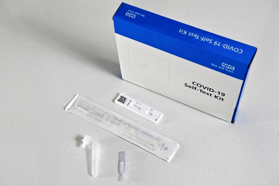 An NHS Covid-19 Self-Test Kit, containing a lateral flow test, is arranged for a photograph in Brenchley, south east England, on April 5, 2021. - From April 8, people living in England will be able to access two free rapid coronavirus tests per week, a measure aimed at curbing symptom-free virus spread. (Photo by BEN STANSALL / AFP) (Photo by BEN STANSALL/AFP via Getty Images)