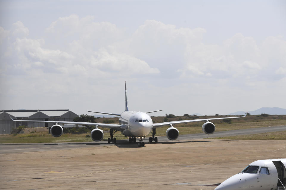 A plane carrying repatriated passengers from Wuhan, China, arrives at the airport in Polokwane, South Africa, Saturday, March 14, 2020, where they will be kept in quarantine at a nearby resort. For most people the new coronavirus causes only mild or moderate symptoms, such as fever and cough. For some, especially older adults and people with existing health problems, it can cause more severe illness, including pneumonia. (AP Photo)