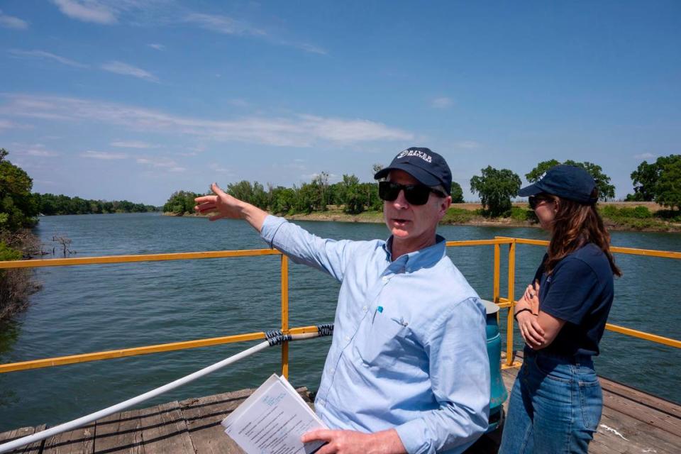 Alex Karolyi of River Partners points on Tuesday to positive changes that will take place after more than 700 acres of farmland at the confluence of the Sacramento and Feather rivers near Knights Landing that his nonprofit environmental restoration group plans to restore to wildlife habitat, and maybe a public park, with help from Apple Inc.