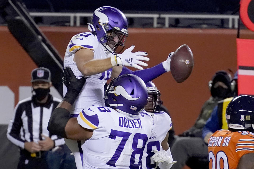 Minnesota Vikings wide receiver Adam Thielen is congratulated by teammate Dakota Dozier (78) after catching a touchdown pass during the second half of an NFL football game against the Chicago Bears Monday, Nov. 16, 2020, in Chicago. (AP Photo/Charles Rex Arbogast)