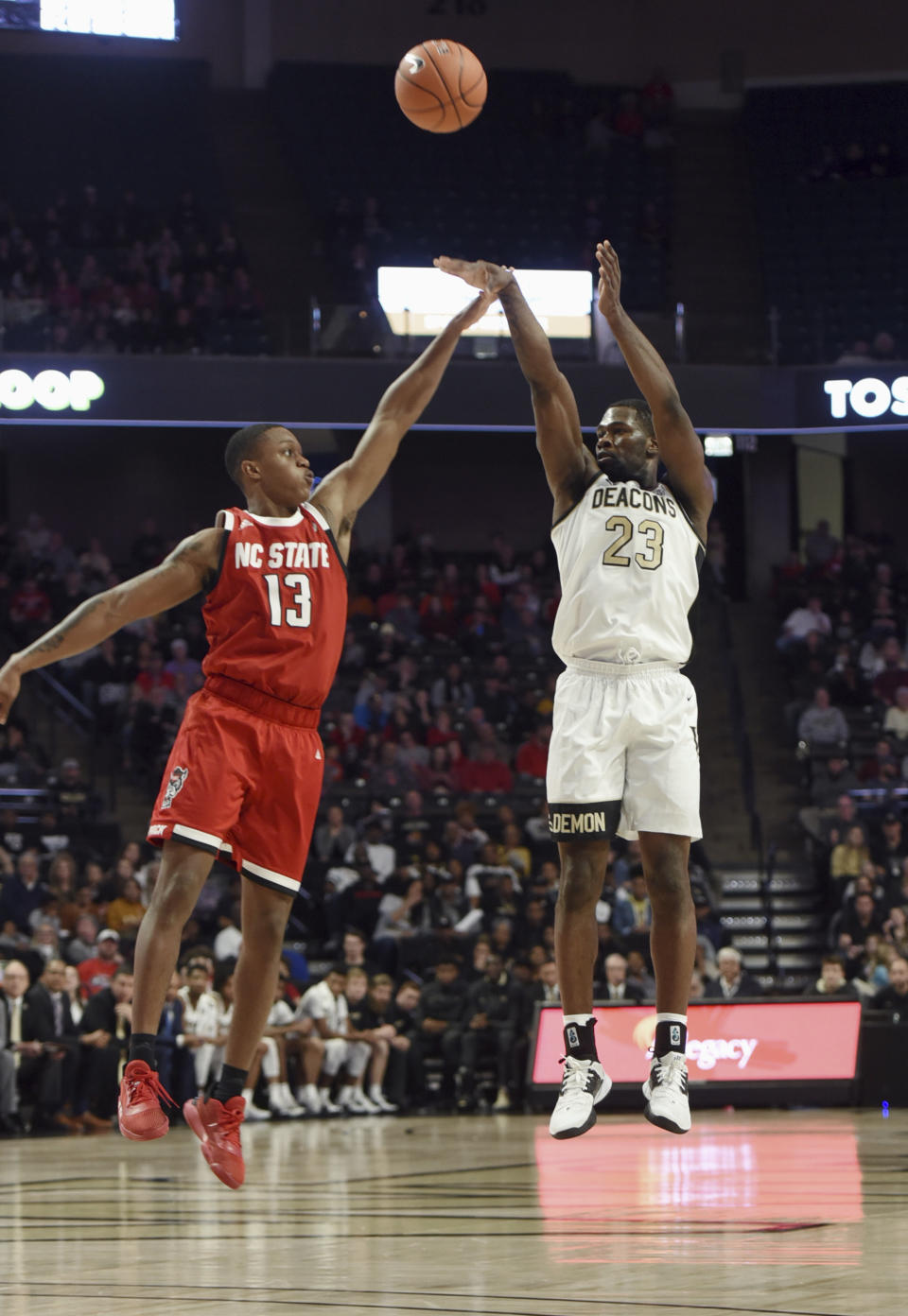 Wake Forest's Chaundee Brown sinks a 3-point shot over N.C. State's C.J. Bryce in the first half of an NCAA men's basketball game, Saturday, Dec. 7, 2019 at Joel Coliseum in Winston-Salem, N.C. (Walt Unks/Winston-Salem Journal via AP)