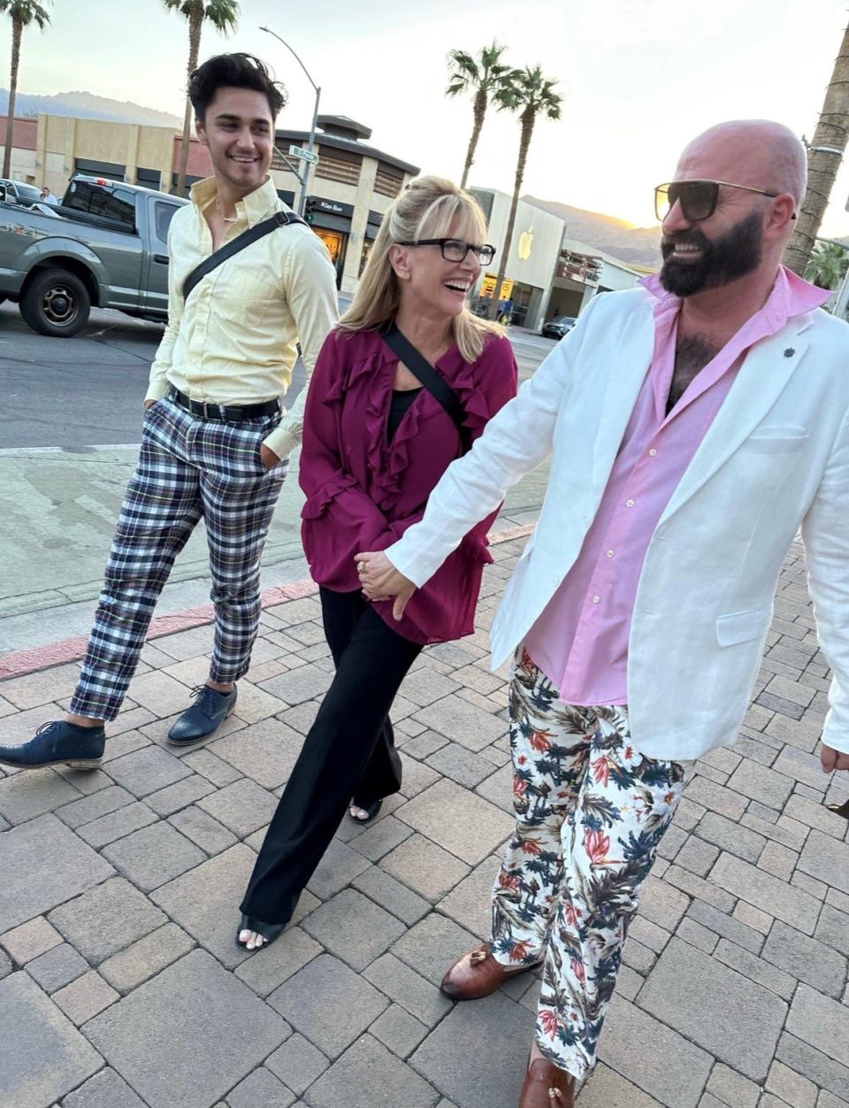 Sandie Newton walks with Chad Allen Ortiz and Michael Nickerson-Rossi.