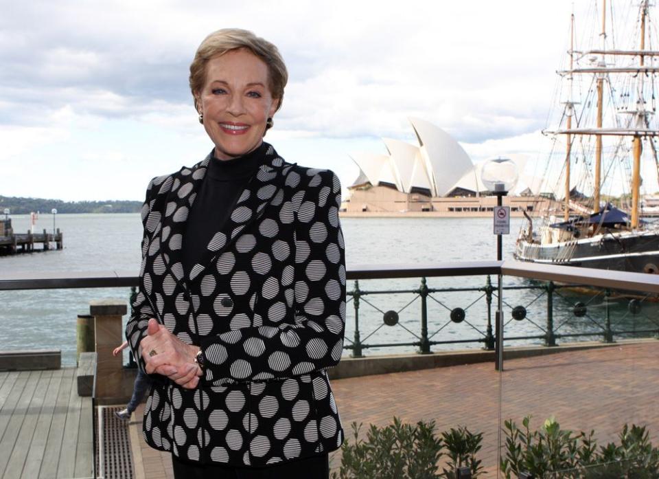 Here, Julie Andrews is seen in a well tailored black suit with white poaching design, black inner-wear and black pant