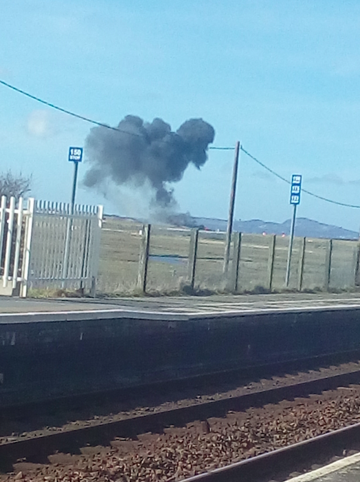 <em>Black smoke filled the air over RAF Valley after the crash (PA)</em>