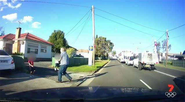 Mr Dring carts the toddler off the road. Source: 7 News