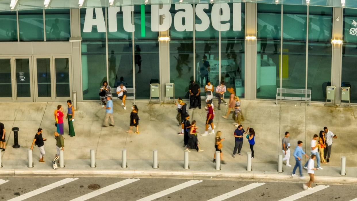 aerial photo people walking by the art basel miami beach