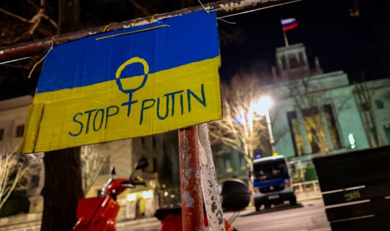A poster reading "Stop Putin" hangs on a railing in front of the Russian Embassy in Berlin. A Ukrainian solidarity group plans to go to court over a ban on projecting images from the war on the facade of the Russian Embassy in Berlin. Hannibal Hanschke/dpa