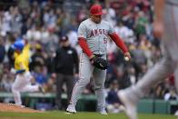 Los Angeles Angels' José Suarez (54) holds the ball after giving up a two-run home run to Boston Red Sox's Masataka Yoshida, back left, during the sixth inning of a baseball game, Sunday, April 14, 2024, in Boston. (AP Photo/Michael Dwyer)