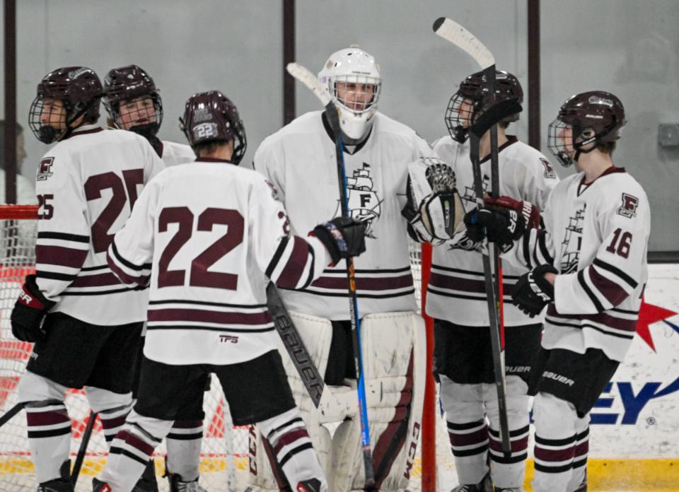 FALMOUTH 01/31/24 Falmouth goalie Ryan Palmer is joined by his teammates after defeating Pilgrim 4-2 in hockey
Ron Schloerb/Cape Cod Times