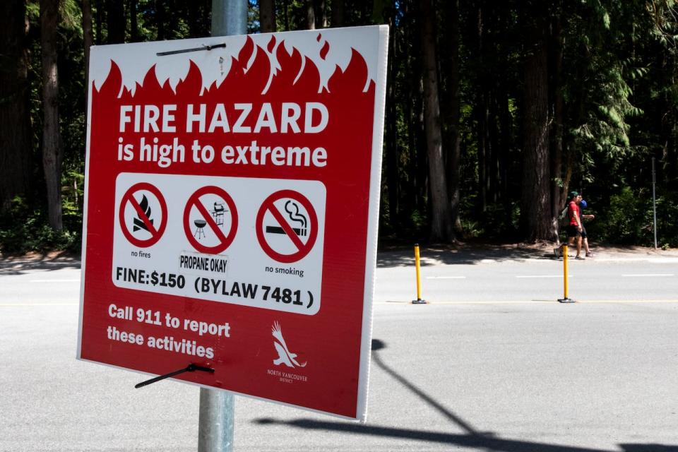 Fire Hazard signs at Lynn Valley Canyon trail heads during B.C.'s wildfire season on July 18, 2023.  Justine Boulin/CBC