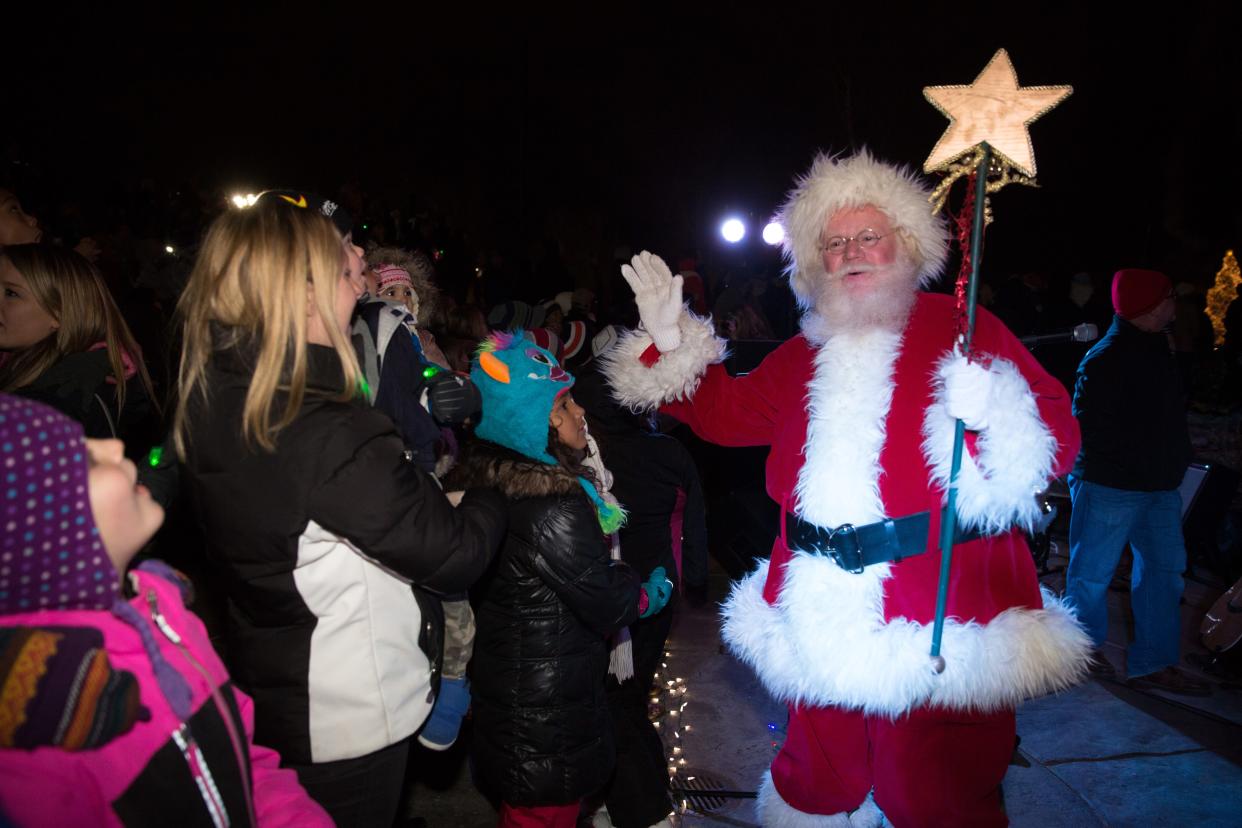 Santa greets customers in 2014 during the tree lighting ceremony and fireworks at the Jordan Creek Town Center in West Des Moines.