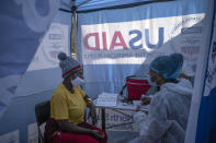 Nurse Nomautanda Siduna talks to a patient who is HIV-positive inside a gazebo used as a mobile clinic in Ngodwana, South Africa, Thursday, July 2, 2020. Across Africa and around the world, the COVID-19 pandemic has disrupted the supply of antiretroviral drugs to many of the more than 24 million people who take them, endangering their lives. An estimated 7.7 million people in South Africa are HIV positive, the largest number in the world, and 62% of them take the antiretroviral drugs that suppress the virus and prevent transmission. (AP Photo/Bram Janssen)