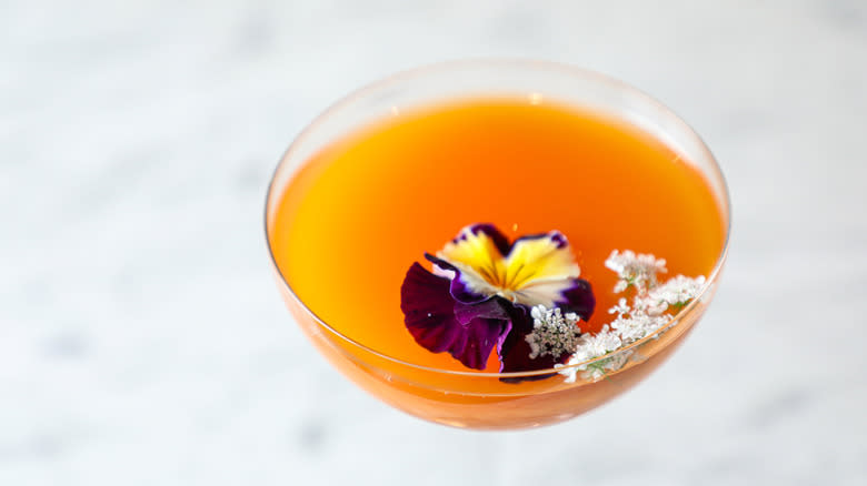 Non-alcoholic beer cocktail with edible flowers