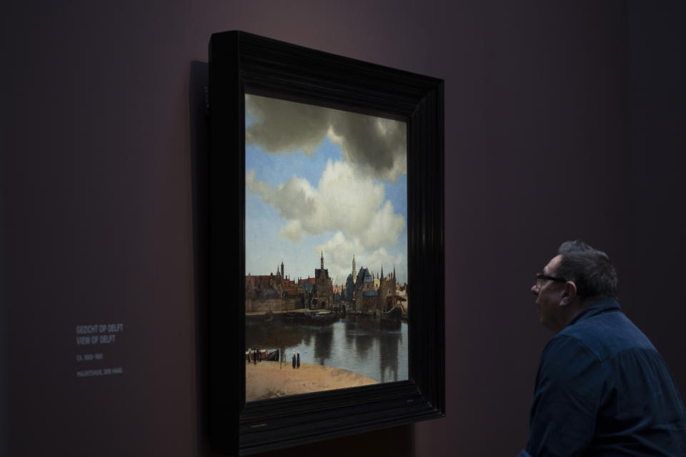 A man looks at View of Delft during a press preview of the Vermeer exhibit at Amsterdam's Rijksmuseum, Monday, Feb. 6, 2023, which unveils its blockbuster exhibition of 28 paintings by 17th-century Dutch master Johannes Vermeer drawn from galleries around the world. (AP Photo/Peter Dejong)
