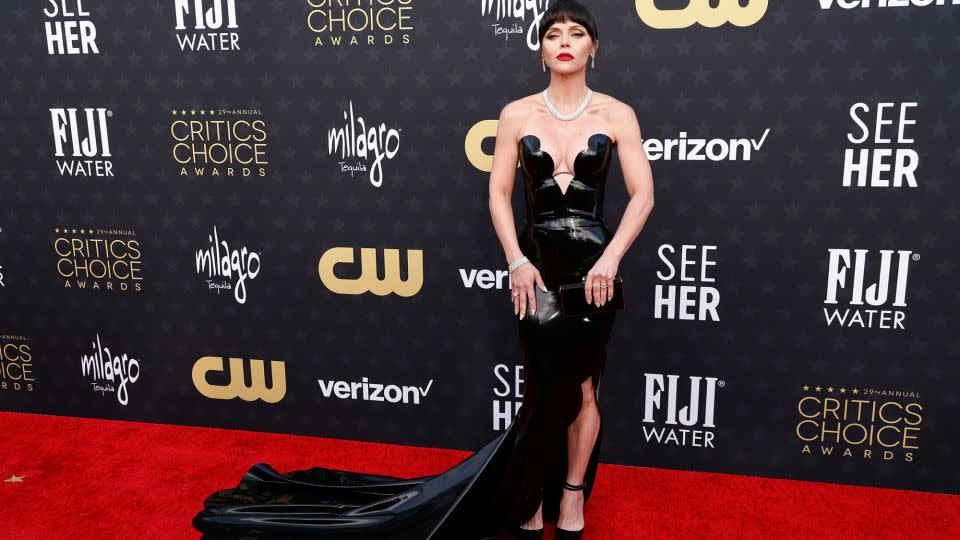 Christina Ricci channeled Morticia Addams with a black latex Atsuko Kudo dress with deep sweetheart neck. She completed the look with a Carolina Herrera clutch and diamond jewelry by Bucherer. - Frazer Harrison/Getty Images