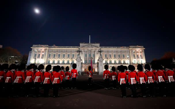 PHOTO: Members of the military stand in front of Buckingham Palace in central London, early Wednesday, May 3, 2023, during a rehearsal for the coronation of King Charles III which will take place at Westminster Abbey on May 6. (Andreea Alexandru/AP)