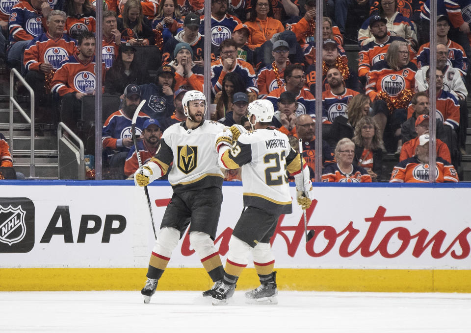 Vegas Golden Knights' Nicolas Roy (10) and Alec Martinez (23) celebrate after a goal against the Edmonton Oilers during second-period NHL hockey Stanley Cup second-round playoff game action in Edmonton, Alberta, Monday, May 8, 2023. (Jason Franson/The Canadian Press via AP)