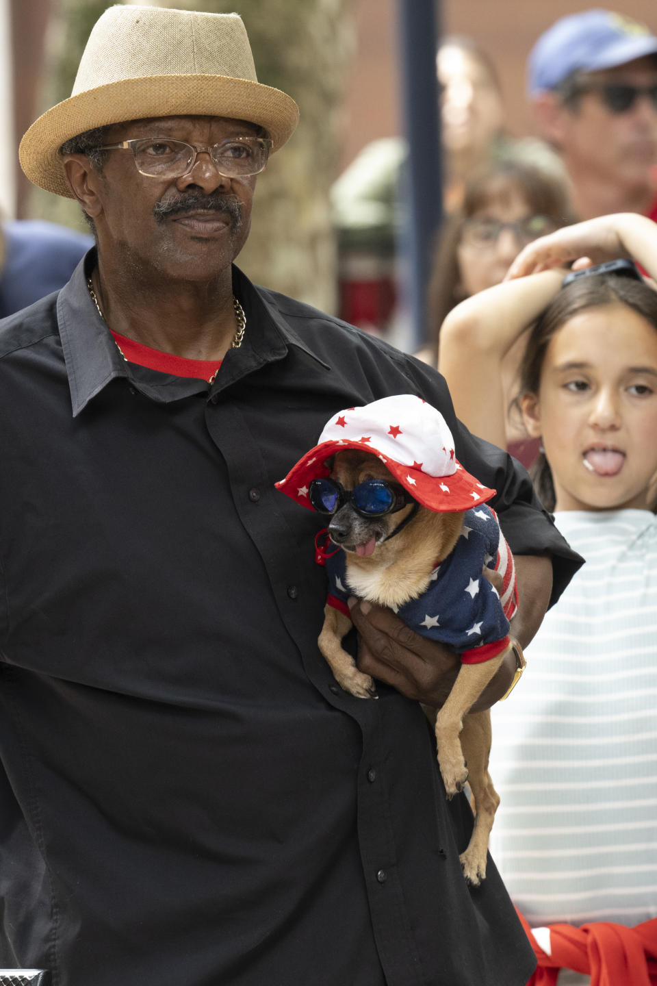 Anthony Smith holds his chihuahua name Mr. Milton on Tuesday July 4, 2023, during the Pet Parade in patriotic costumes contest at the Betsy Ross House in Philadelphia. (Jose F. Moreno/The Philadelphia Inquirer via AP)